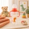 BabyBruin műanyag karcsúsított cumisüveg fogóval 240 ml (narancssárga)